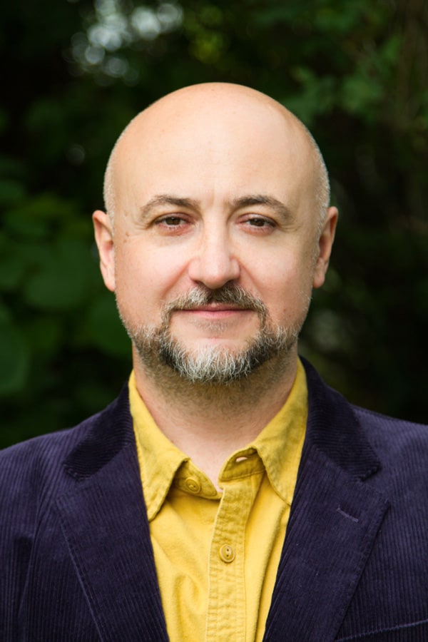 Photographer Branko Arsov headshot in yellow button down shirt and dark blue blazer