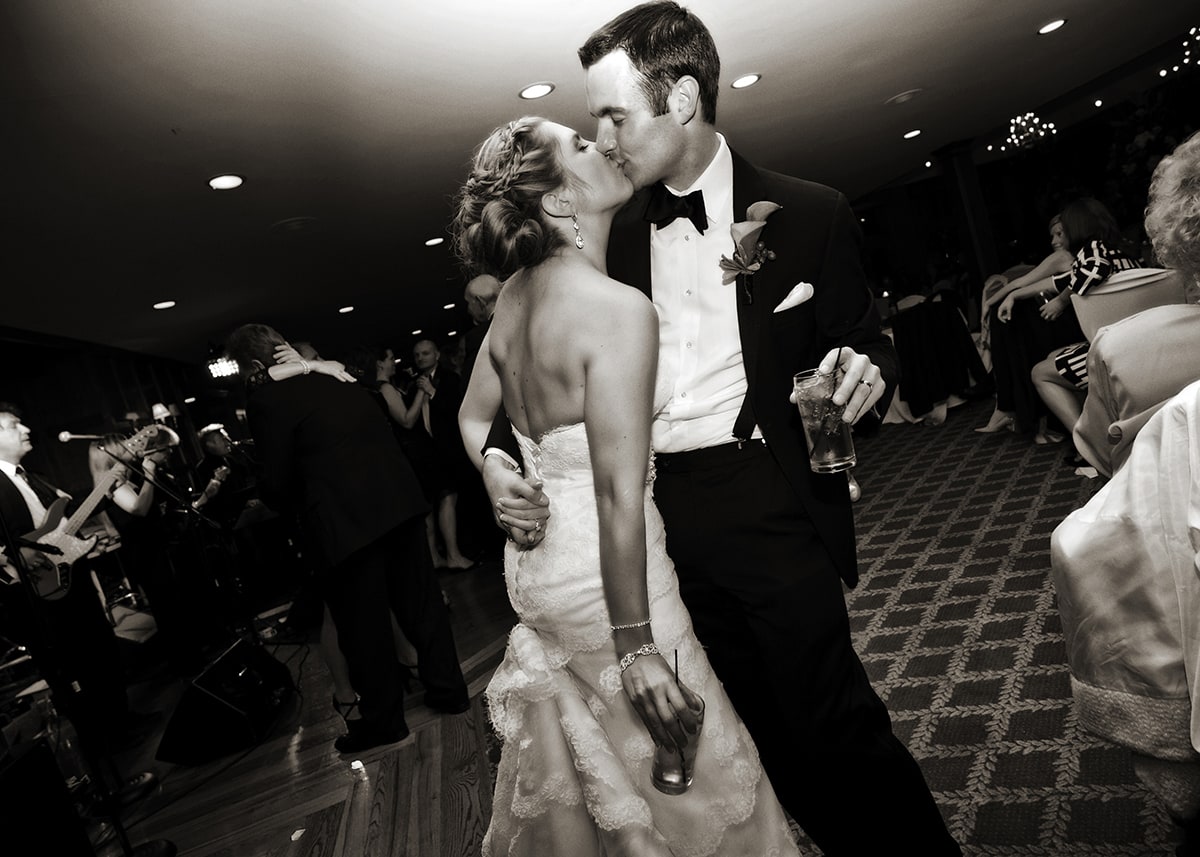 Bride and groom kissing on dance floor