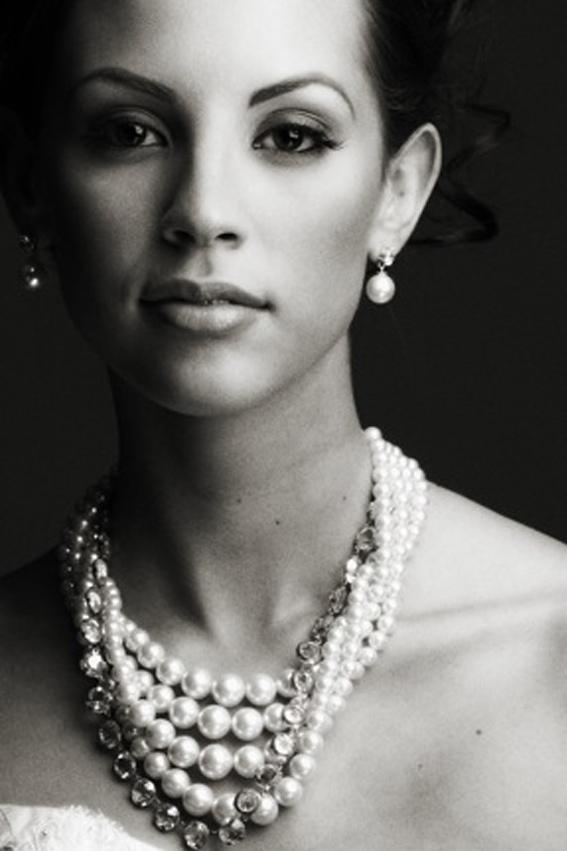 Elegant woman wearing large string of pearls